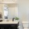 Model bathroom at our senior living apartments in Buford, GA, featuring white countertops and black cabinetry