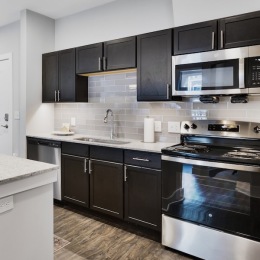 a kitchen with black cabinets