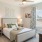 Model bedroom at our senior living apartments in Buford, GA, featuring carpeted flooring and windows with curtains
