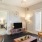 Model living room at our 55 and over apartments in Buford, GA, featuring a flat screen TV and cushioned chairs