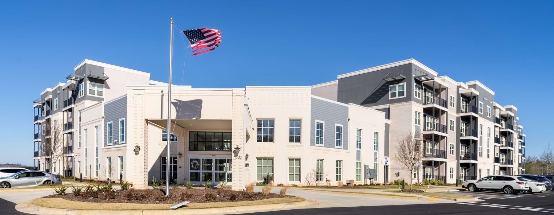 an apartment complex with a flag