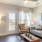 Model living room at our 55 and over apartments in Buford, GA, featuring a flat screen TV and wood grain flooring
