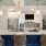 a kitchen with a bar and chairs